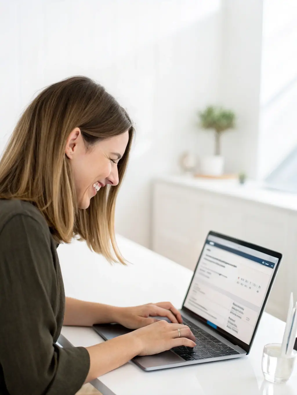 A person happily filling out an online form on a laptop, representing the easy online application process for the AstroCoach affiliate program.